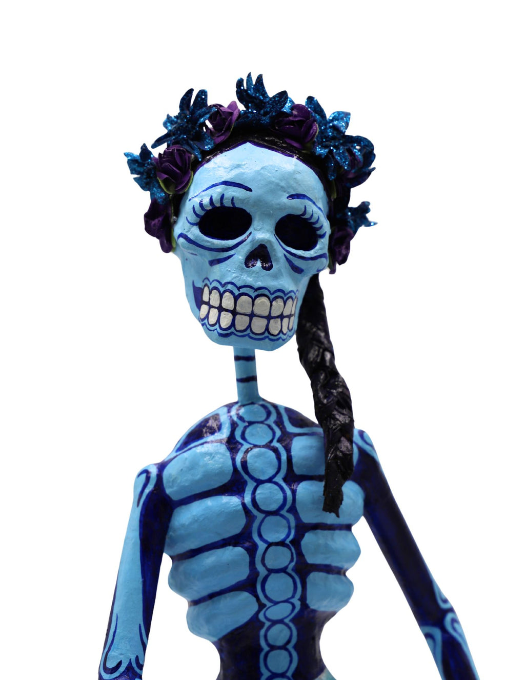 A papier-mâché figurine painted in light blue and dark blue, featuring a floral crown and a long black braid.