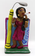 A ceramic figurine of a woman in a sparkly pink dress holding an oversized cigarette under a street light. 