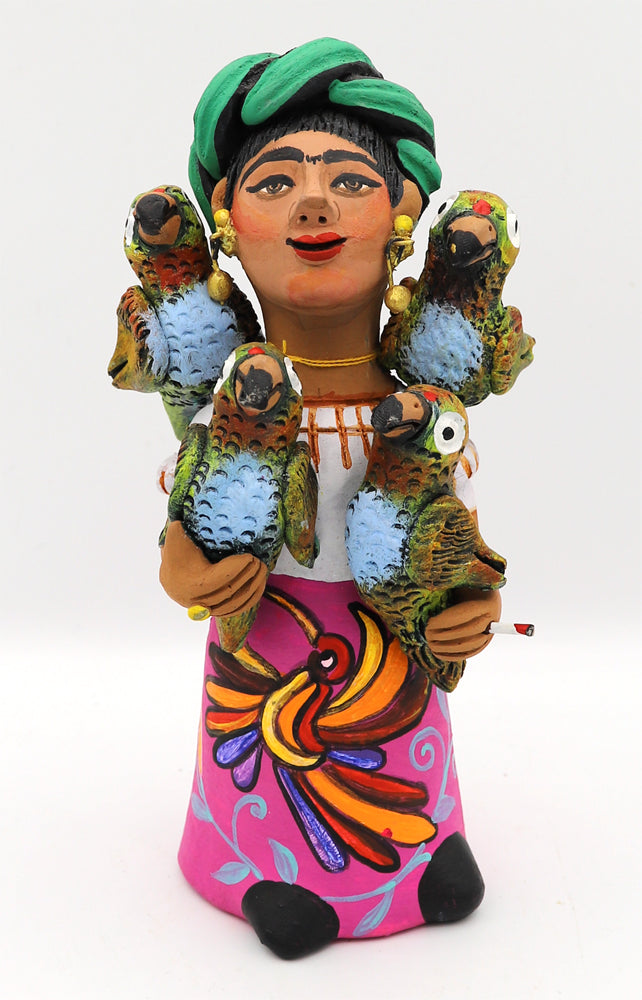 Colorful ceramic figurine of a woman holding parrots.