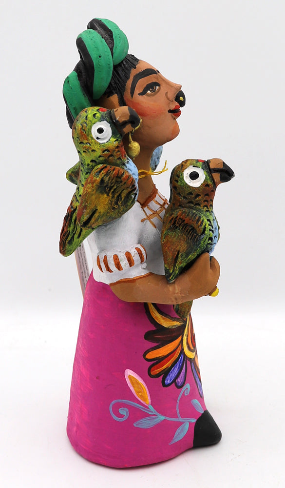 Colorful ceramic figurine of a woman holding parrots.