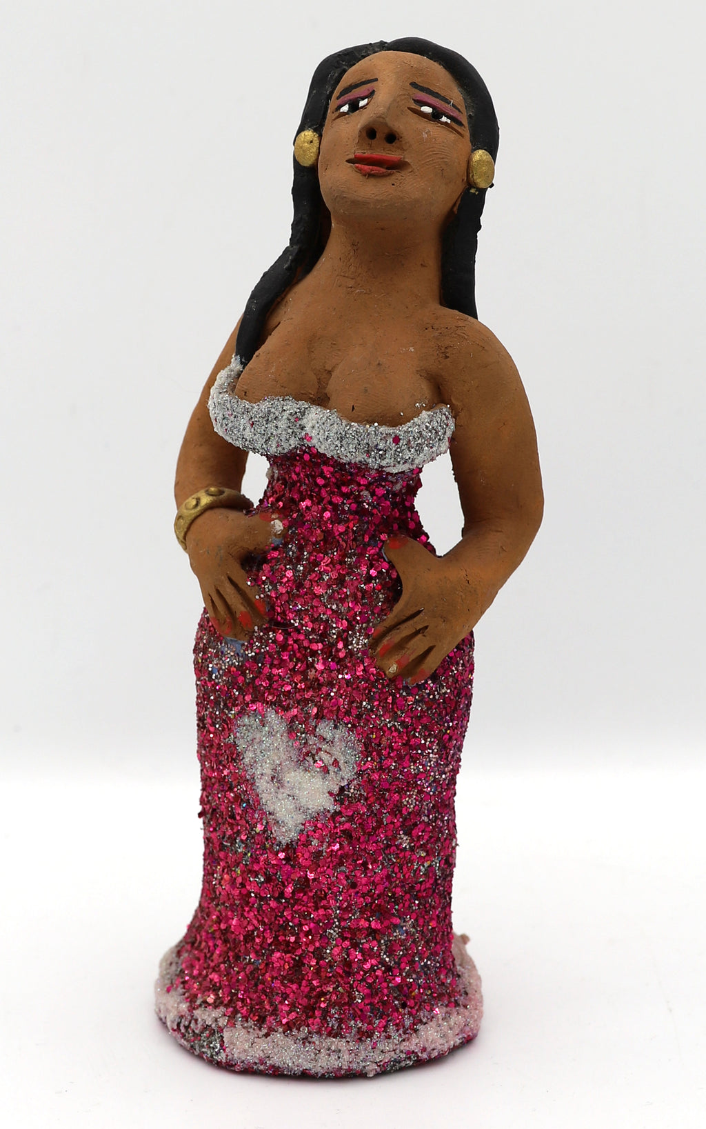A ceramic sculpture of a woman in a sparkly pink dress. 