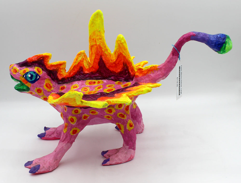 Colorful creature figurine with pink body, yellow spikes, and spots.