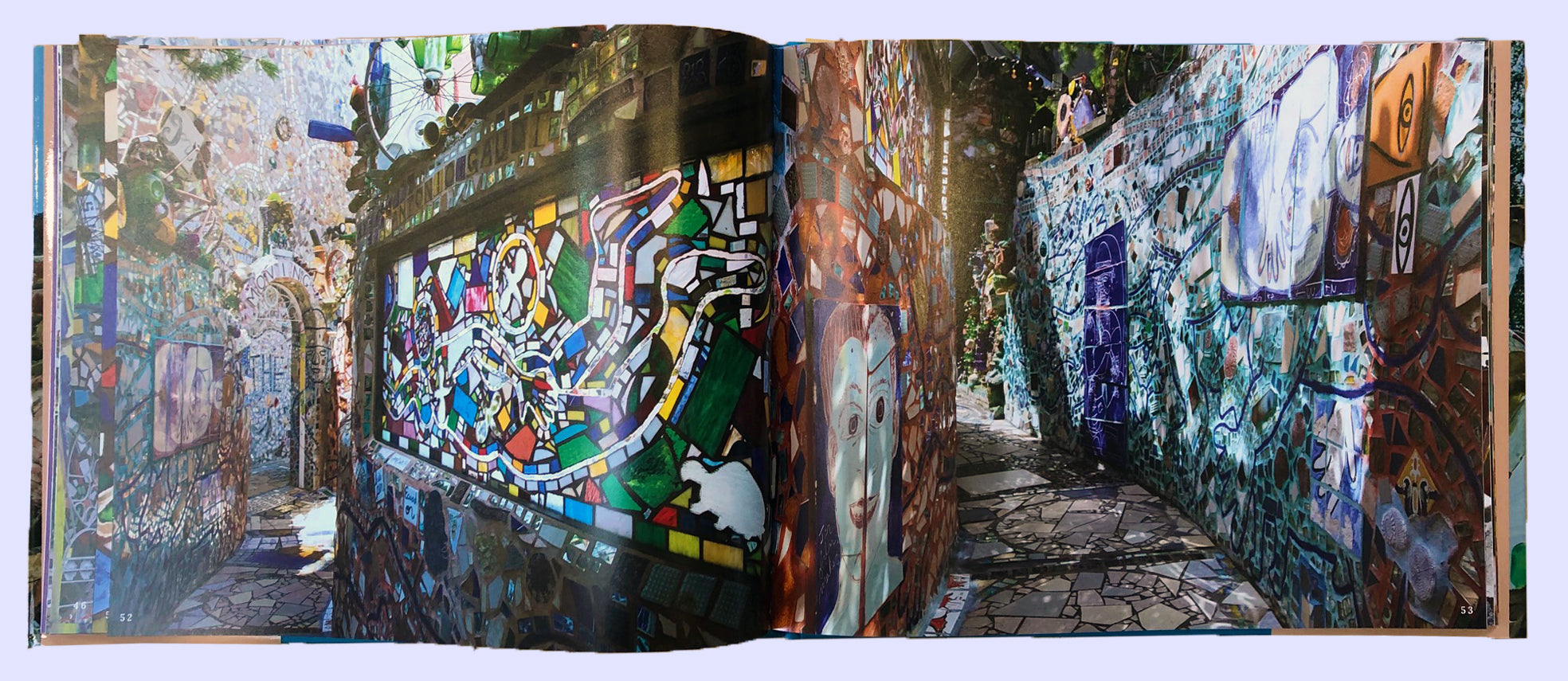Open book with full-page images of the Magic Gardens Museum