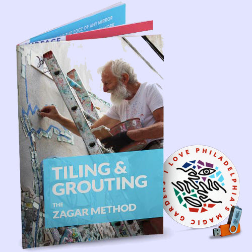 Book titled 'Tiling & Grouting: The Zagar Method' with Isaiah Zagar on the cover, and a zip drive in the corner.