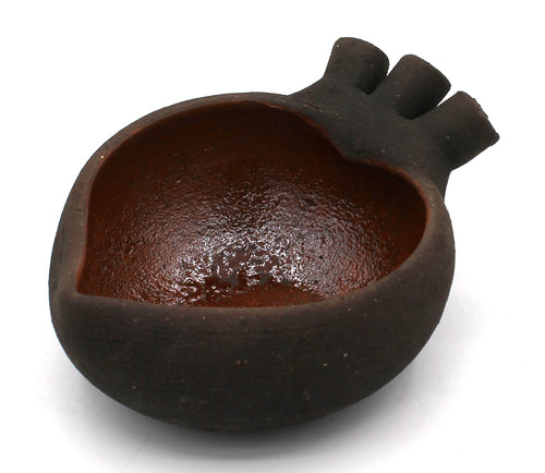 Ceramic heart-shaped dish with black exterior and brown interior. Handmade in Mexico. Measures 1.5" x 2.75" x 3.25"