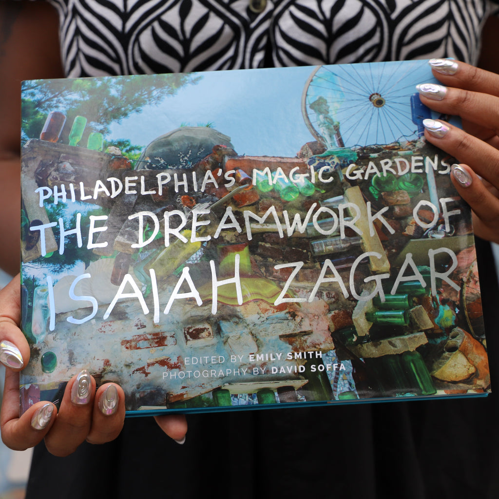 The cover of a book titled "Philadelphia's Magic Gardens The Dreamwork of Isaiah Zagar" with the image of a mosaicked wall on it. 