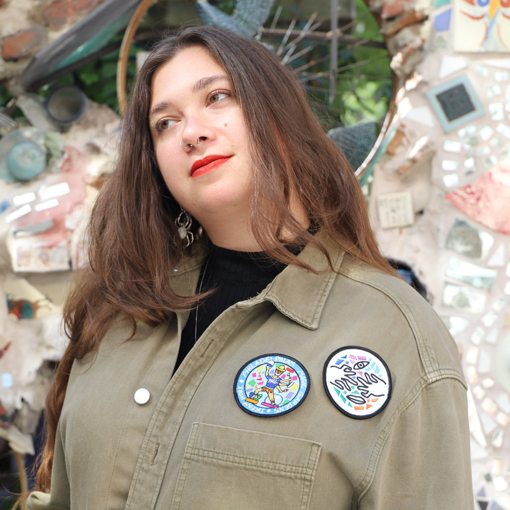 A woman wearing two Philadelphia's Magic Gardens patches on her 