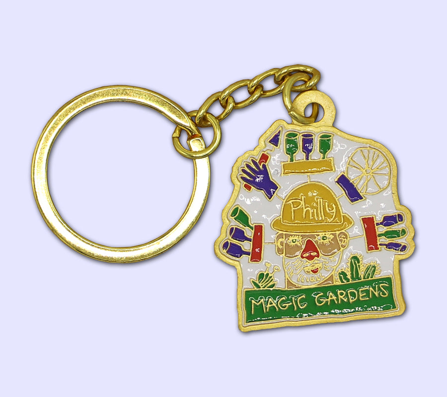 Enamel gold keychain (pendant measures 1.25"x1.25") featuring an original drawing of and by PMG founding artist Isaiah Zagar.