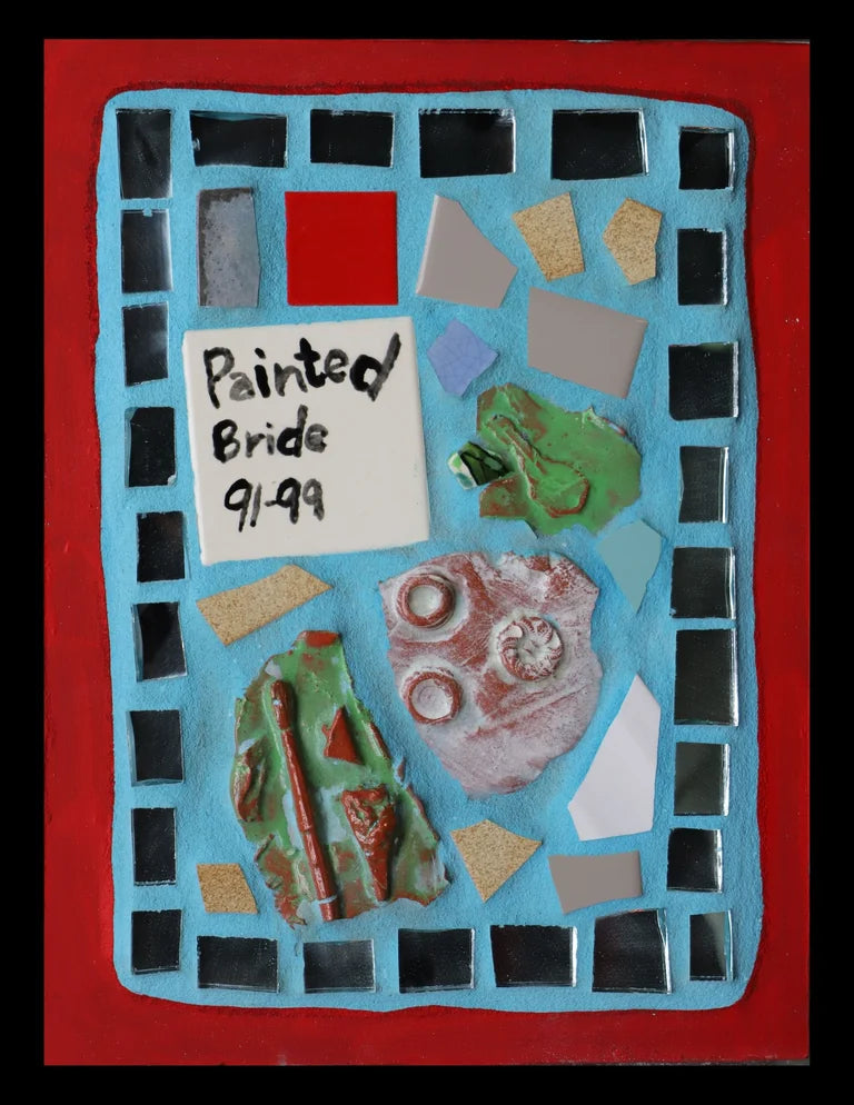 Mosaic art piece with colorful tiles on  blue grout and a red border, featuring a tile that reads 'Painted Bride 91-99'.