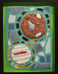 Framed mosaic feature two round tiles surrounded by mirror and other tiles on blue grout with a green border.