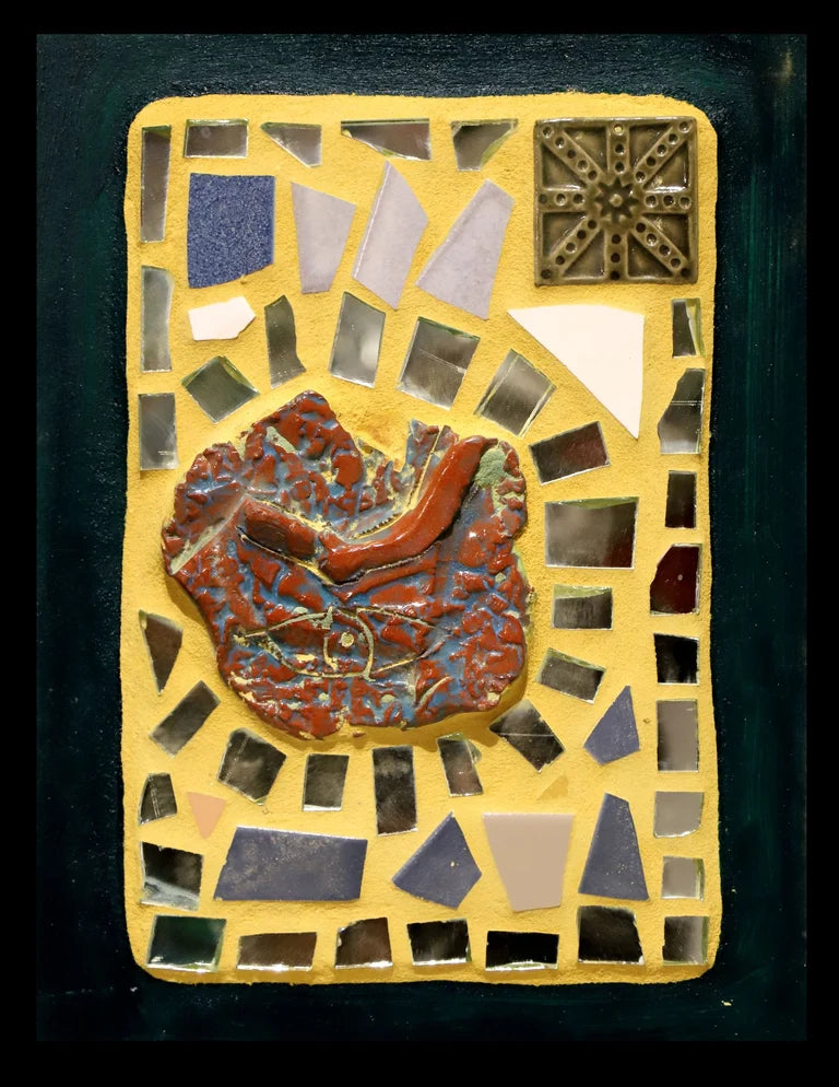 Framed mosaic with mirror pieces and tiles on yellow grout with a blue-green border.