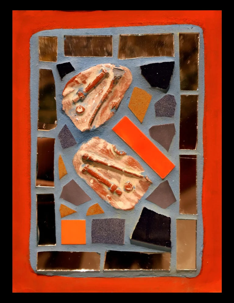 Small mosaic with colorful tiles and mirror pieces on blue grout with an orange border.