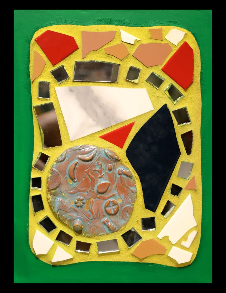 Small mosaic with colorful tiles and mirror pieces on yellow grout with a green border.